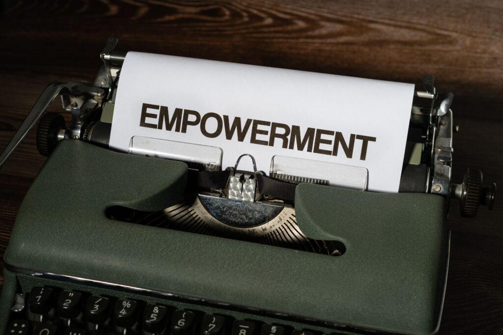 pexels-photo-12220435-12220435 Close-up of a vintage typewriter with the word 'empowerment' on paper, symbolizing strength.